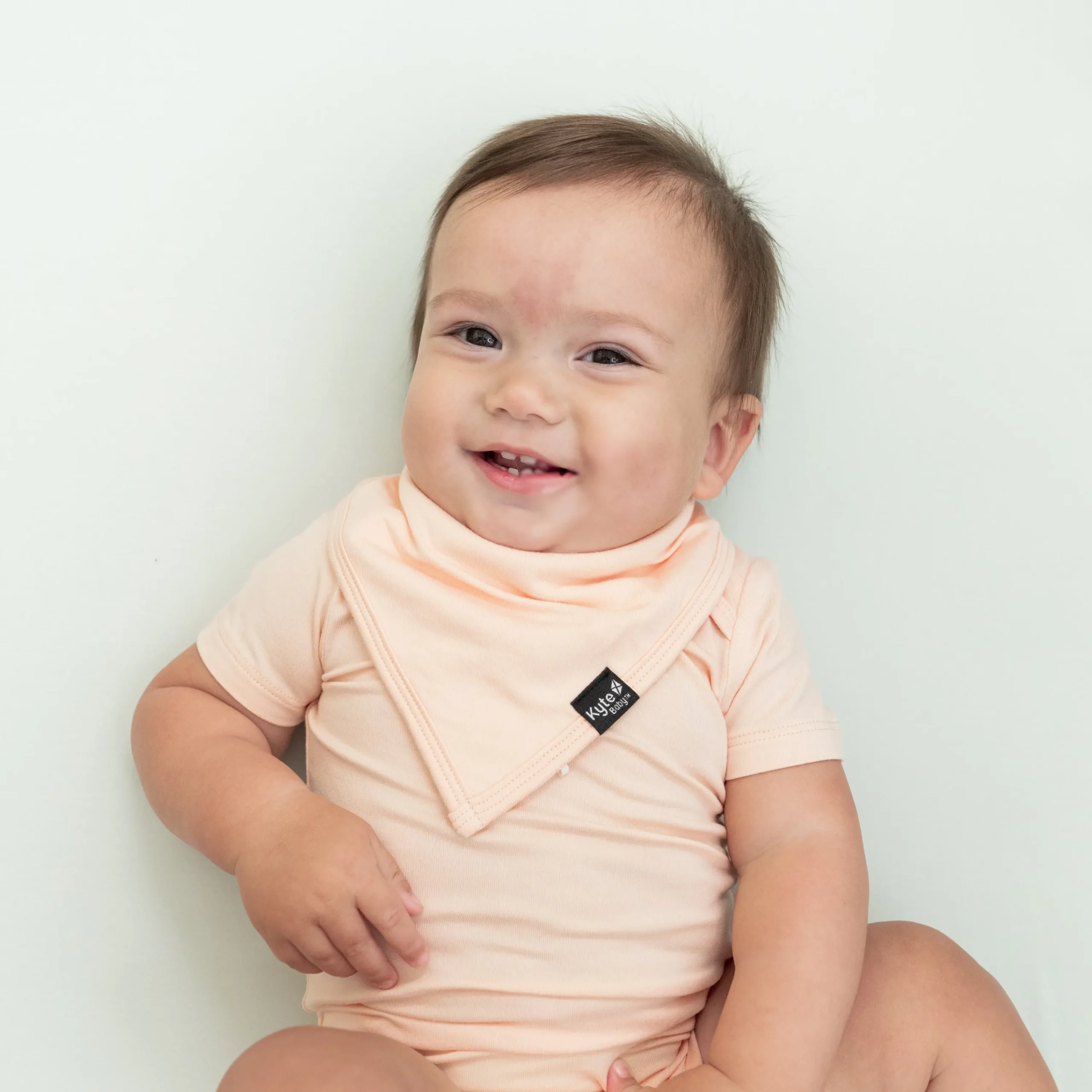 Kyte Baby Bib in Canyon Hot
