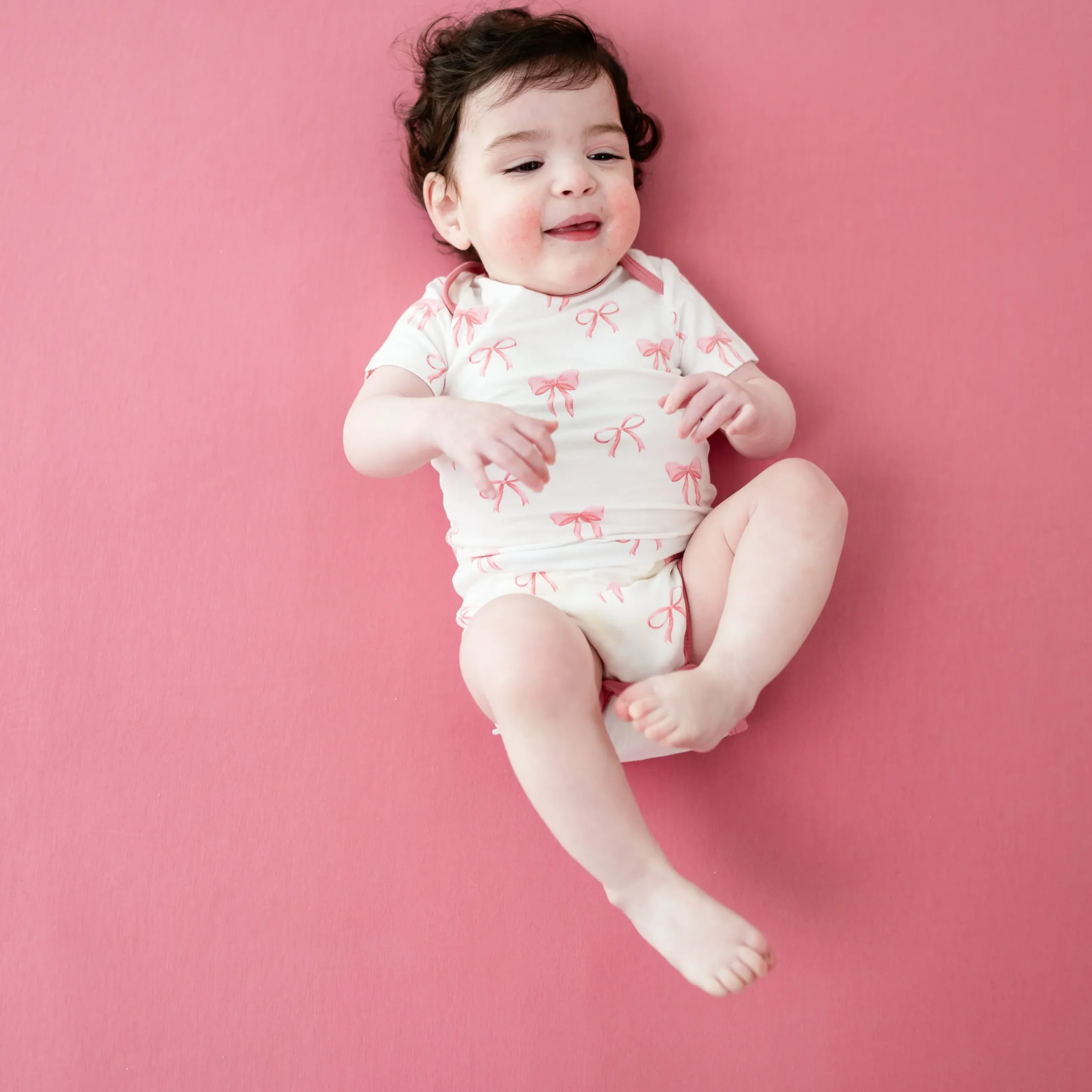 Kyte Baby Bodysuit in Bow Hot