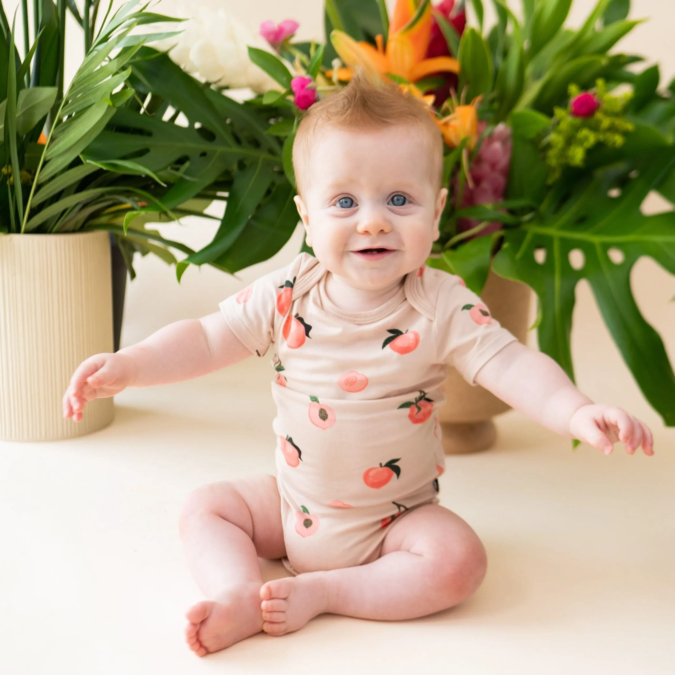 Kyte Baby Bodysuit in Peach Hot