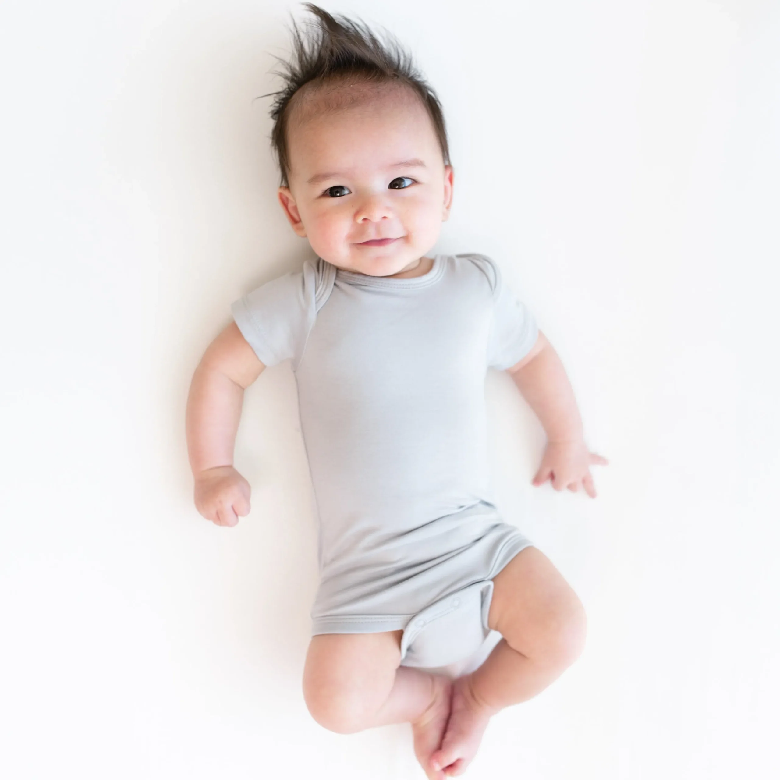 Kyte Baby Bodysuit in Storm Hot