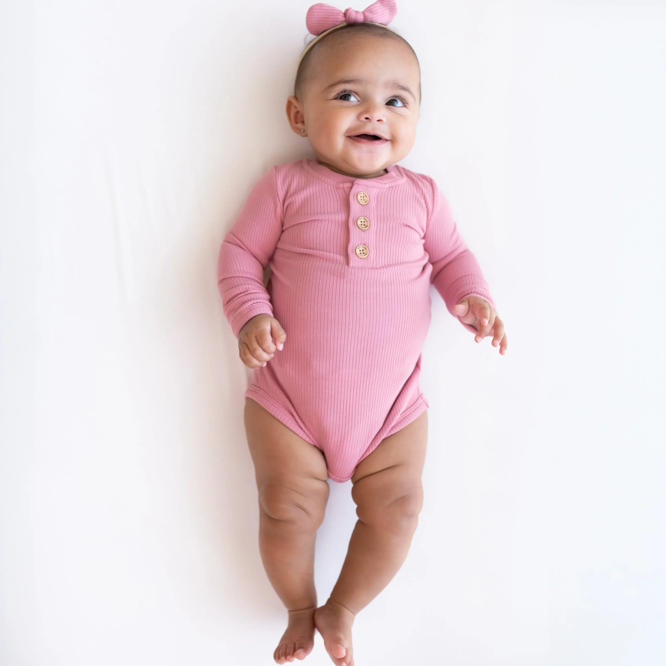 Kyte Baby Ribbed Long Sleeve Henley Bodysuit in Apple Blossom Clearance