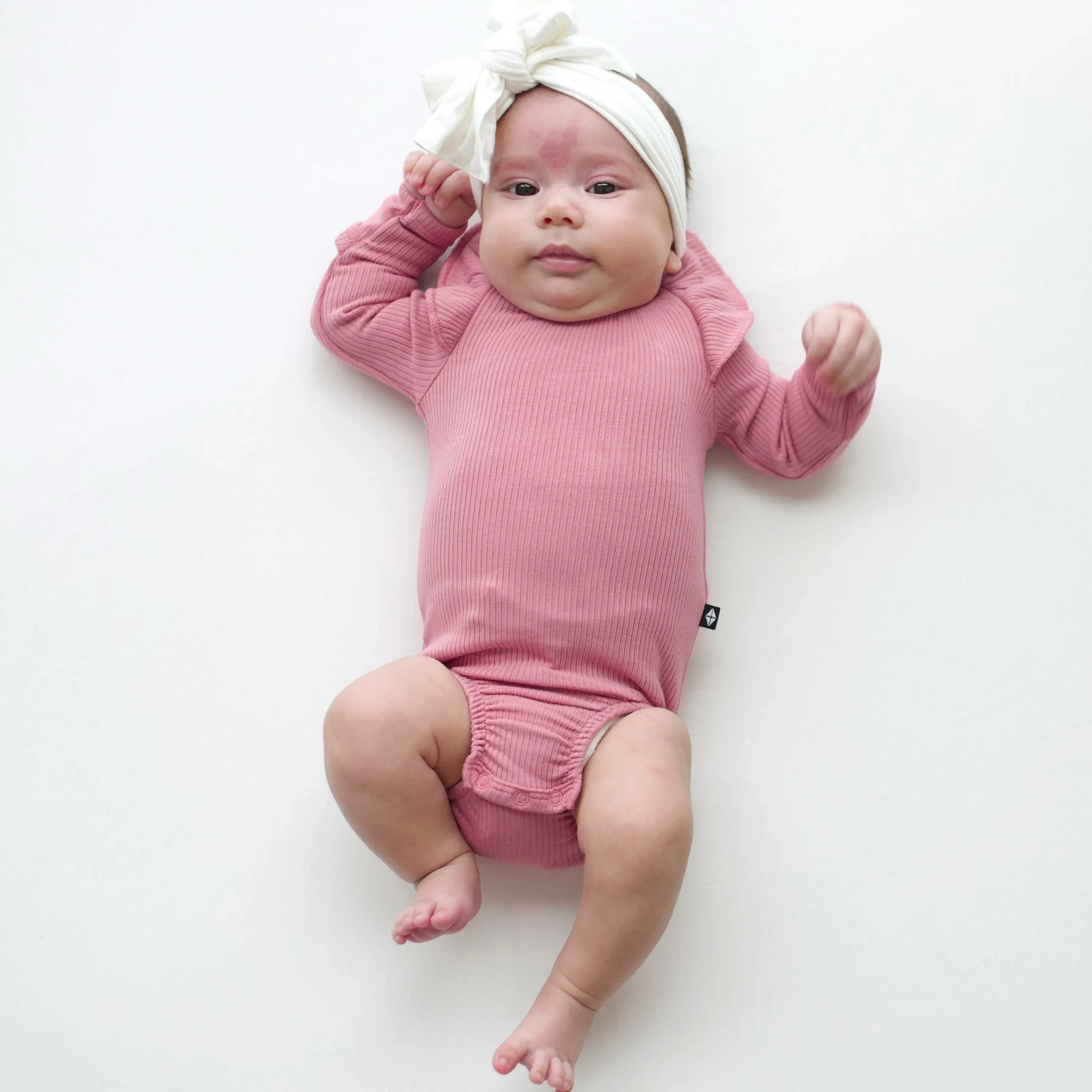 Kyte Baby Ribbed Long Sleeve Ruffle Leotard in Apple Blossom Online