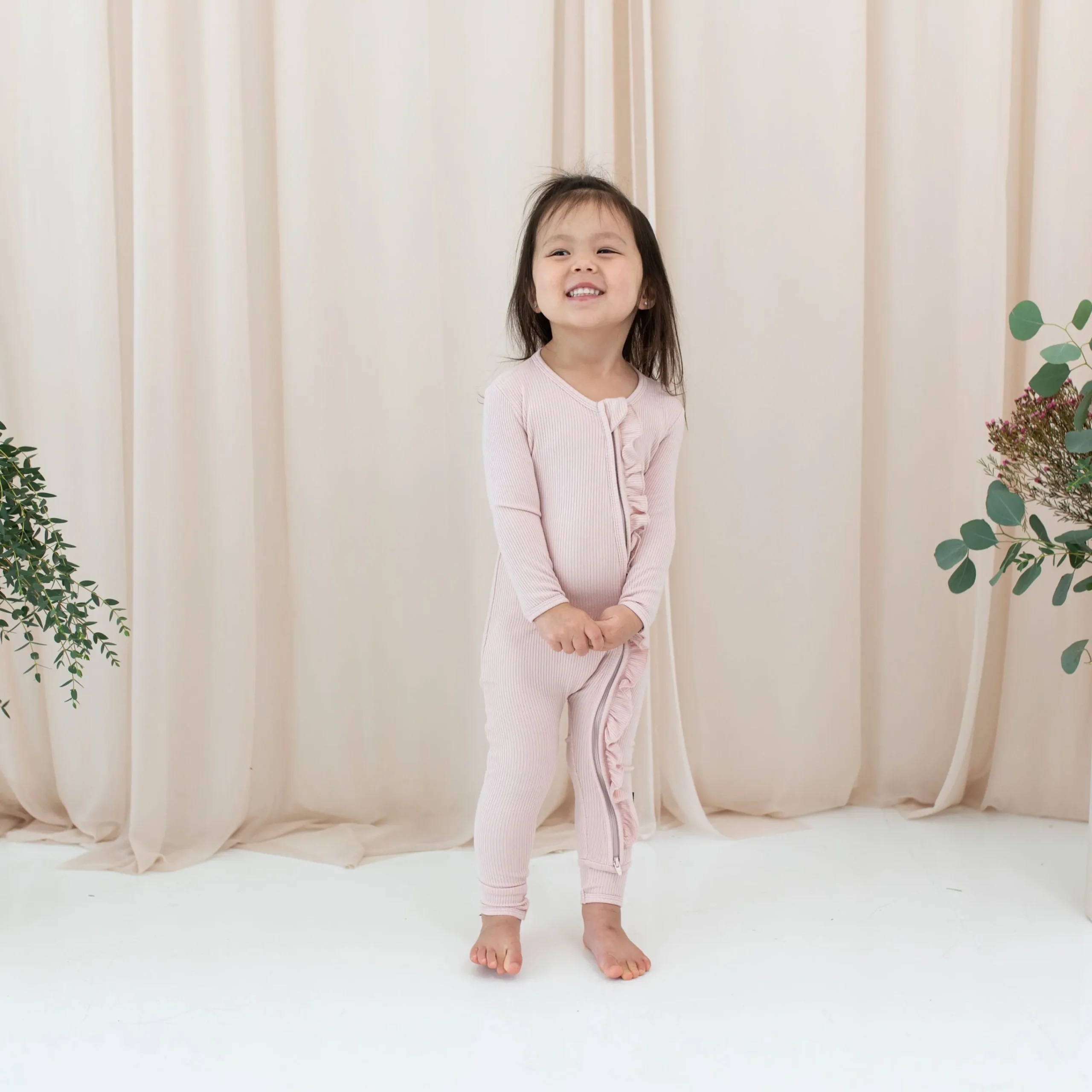 Kyte Baby Ribbed Ruffle Zipper Romper in Blush Hot