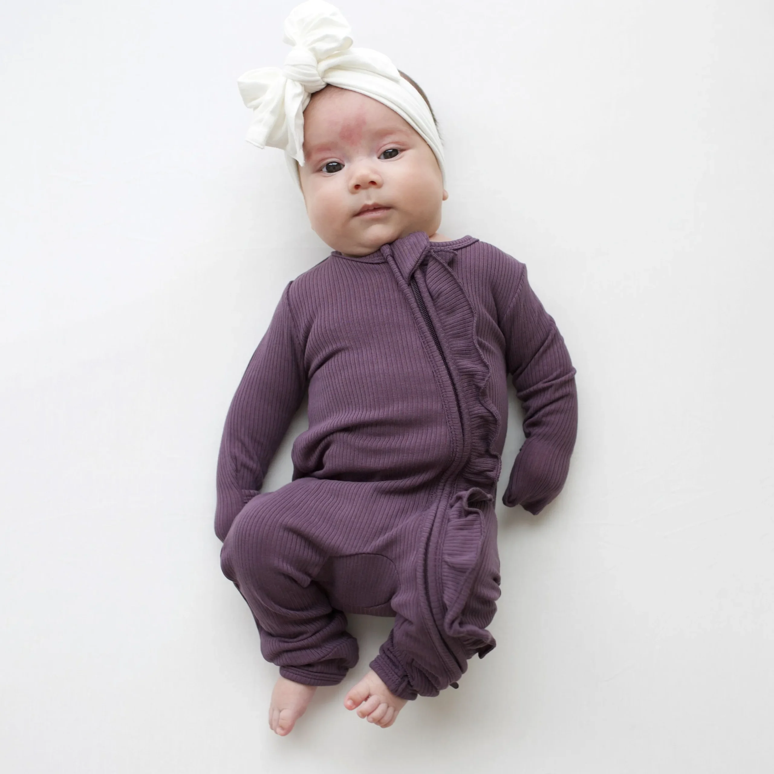 Kyte Baby Ribbed Ruffle Zipper Romper in Currant Clearance