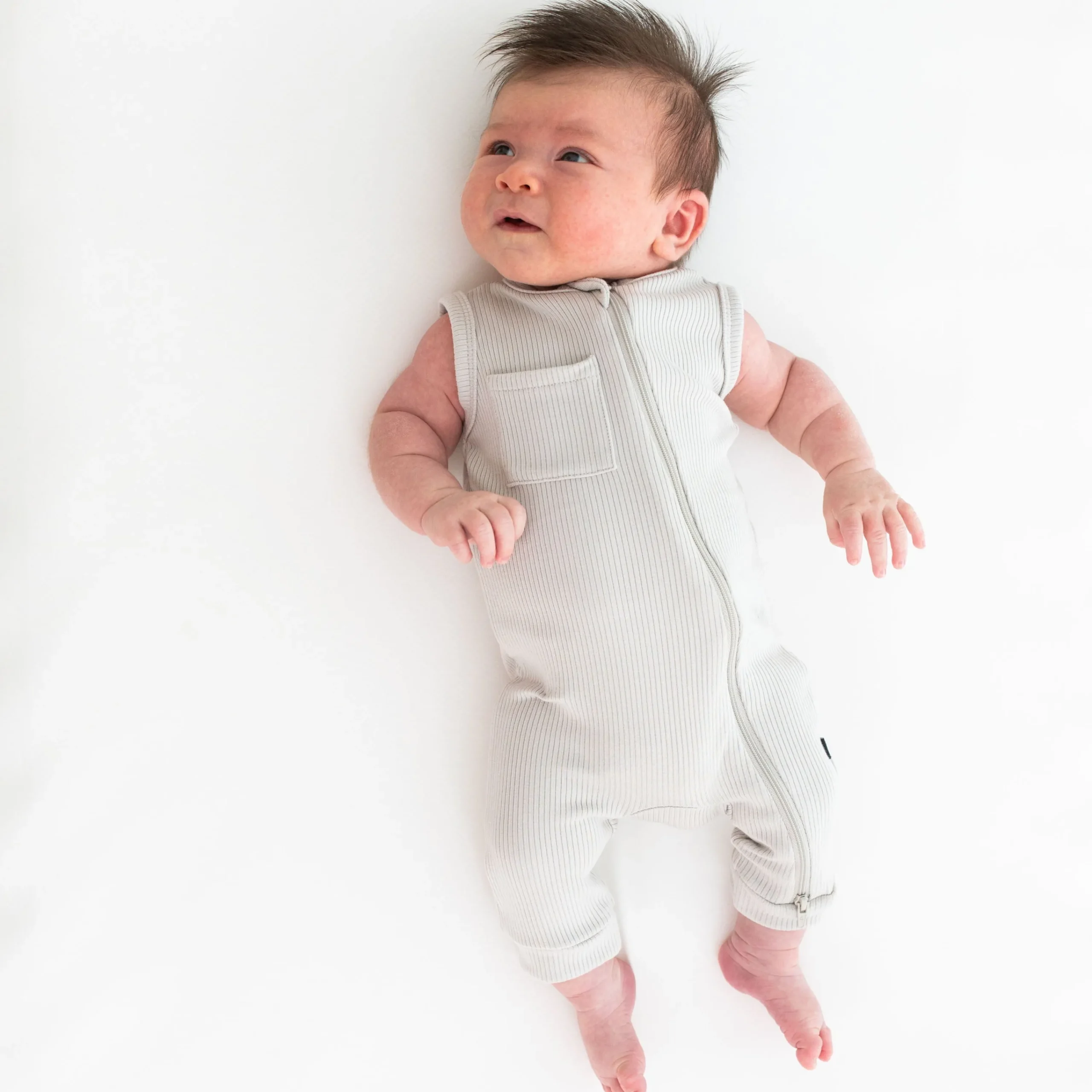 Kyte Baby Ribbed Zippered Sleeveless Romper in Oat